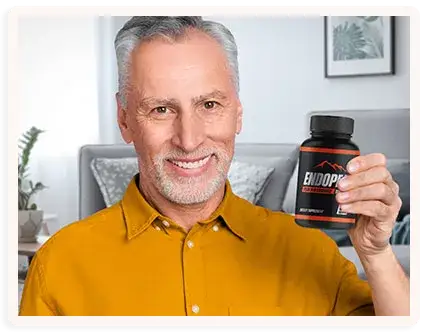Smiling man holding EndoPeak® dietary supplement bottle